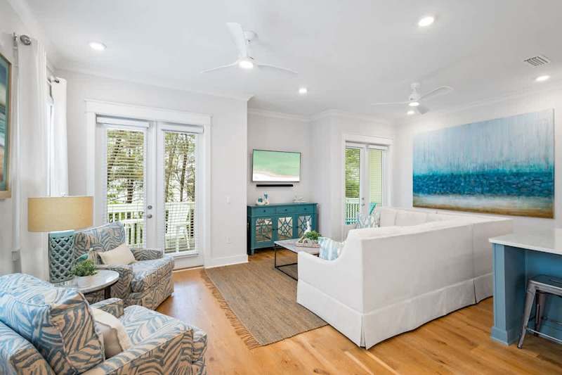 Living room includes ample seating and a smart tv.