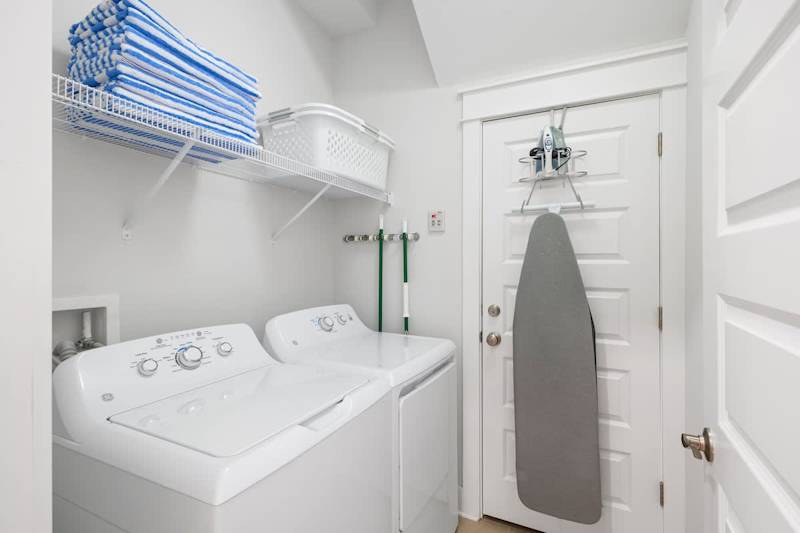 Main floor laundry room features a full washer & dryer.