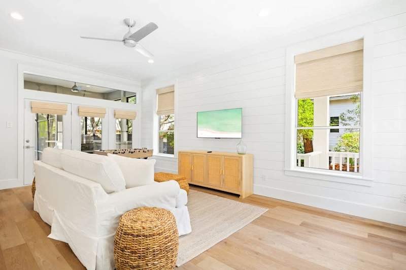 Upon entering the home you are welcomed by an open concept living area, featuring a queen sleeper sofa, smart tv and foosball table.