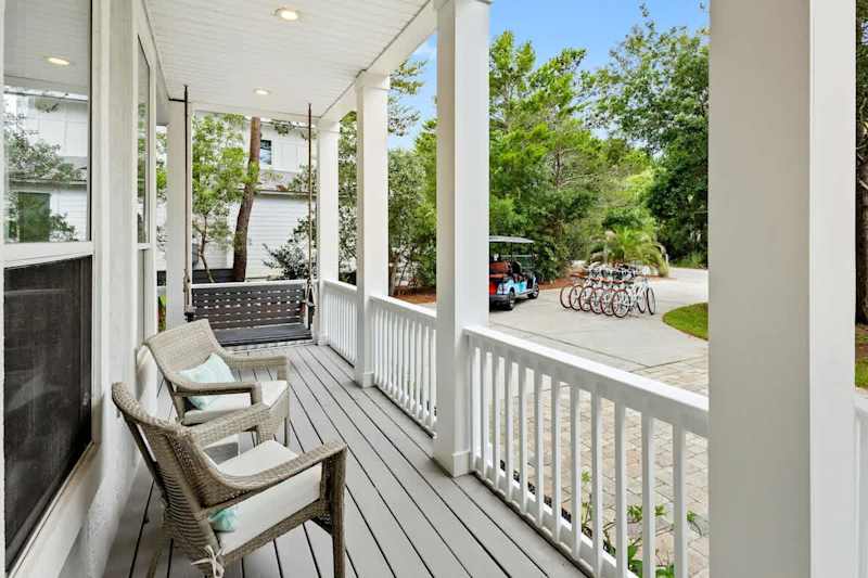Large front porch has multiple seating options perfect for enjoying a morning cup of coffee.