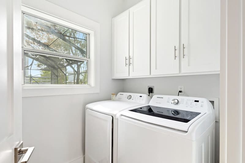 First floor laundry room features a full washer and dryer.