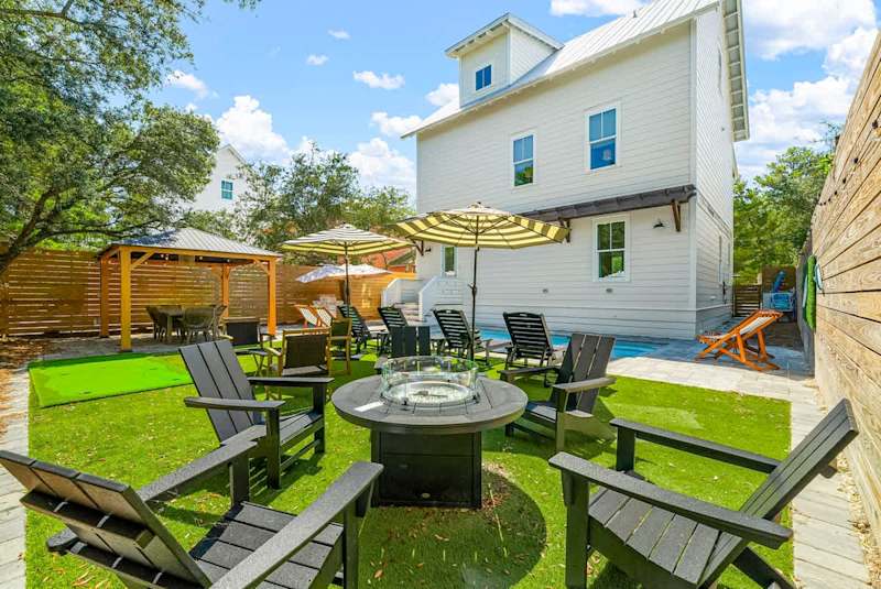 Backyard features firepit and plenty of seating areas, perfect for entertaining.