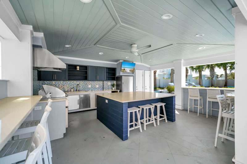 Outdoor kitchen to enjoy meals by the pool.
