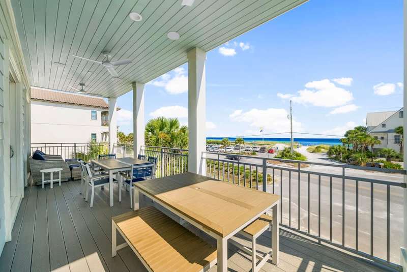 Large second floor balcony off living includes ample seating and Gulf views.