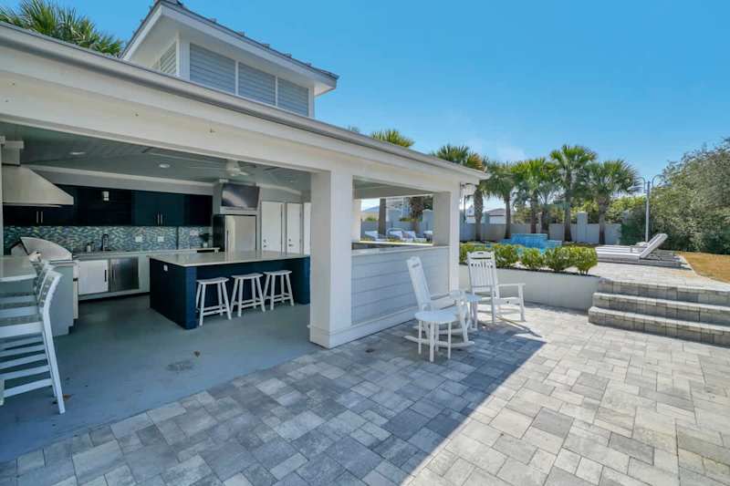 Home features a resort style private pool area with outdoor kitchen.