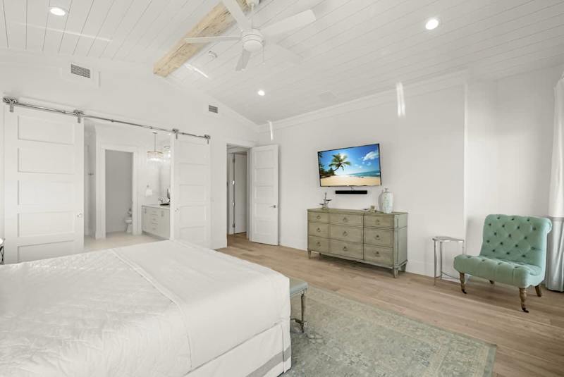 Bedroom #5 features a king bed, smart TV, ensuite & views/access to porch.