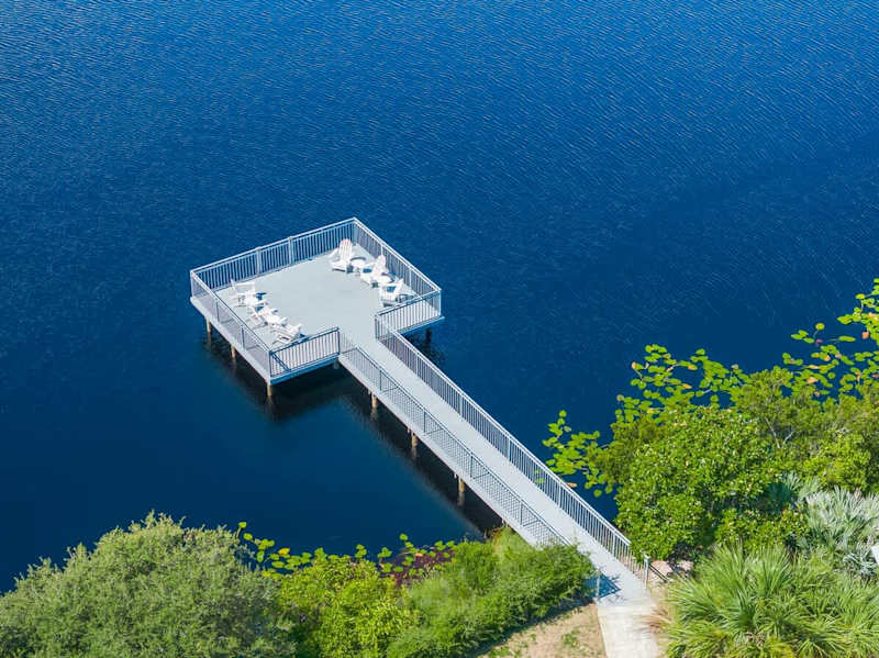 Home features an outdoor deck over the dune lake with seating, perfect for morning coffee and 30A sunsets.