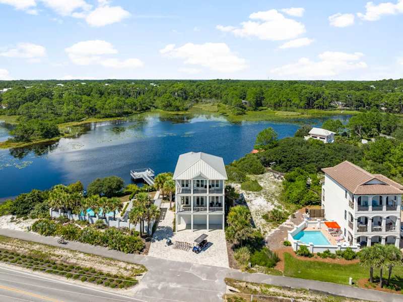 Home features an outdoor deck over the dune lake with seating, perfect for morning coffee and 30A sunsets.