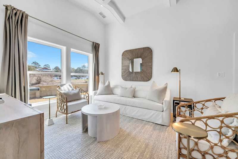 Living room features a large smart tv and plenty of seating.