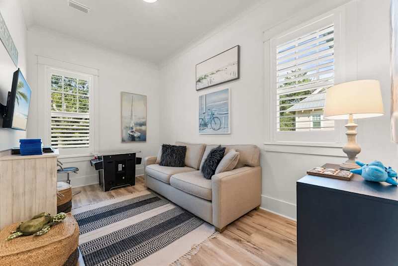 Loft living area with a pacman game & TV perfect for movie nights!