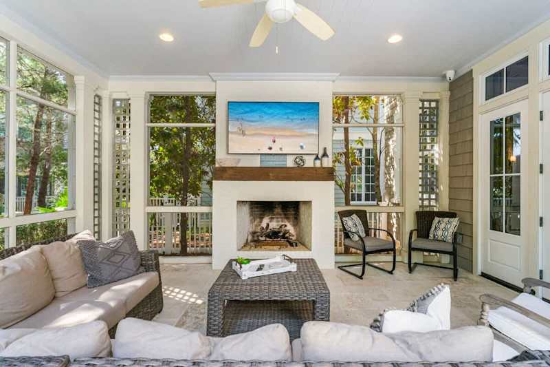 Screened-in patio off living room with seating for all.