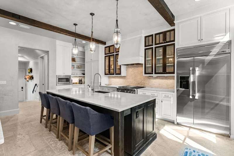 Fully stocked kitchen with island seating for 4. Perfect for preparing family meals!