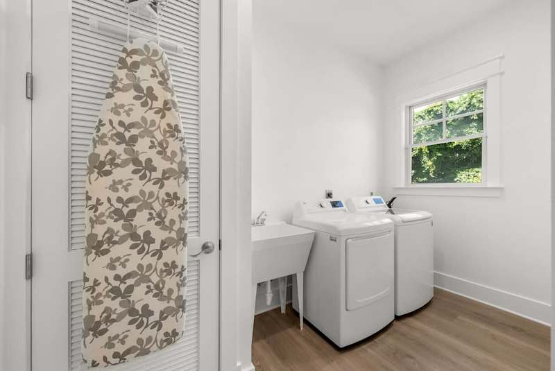 Second floor laundry features a full washer and dryer.