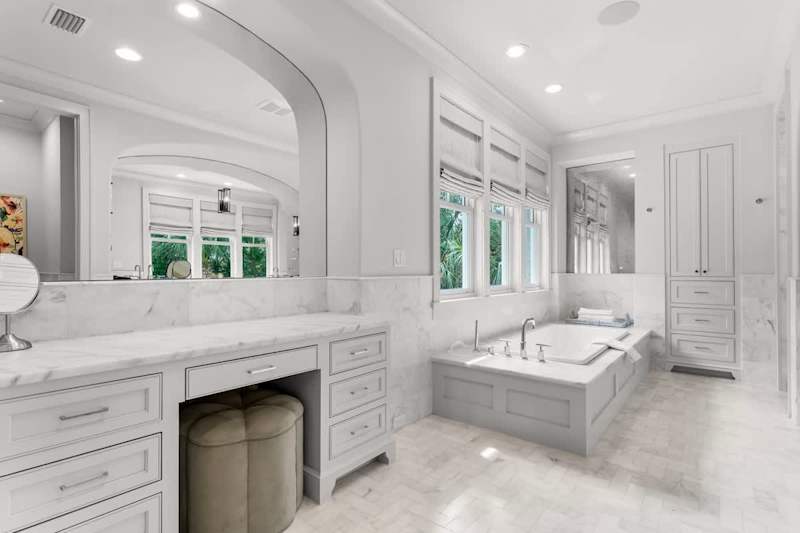 Bathroom features walk-in shower and soaking tub.
