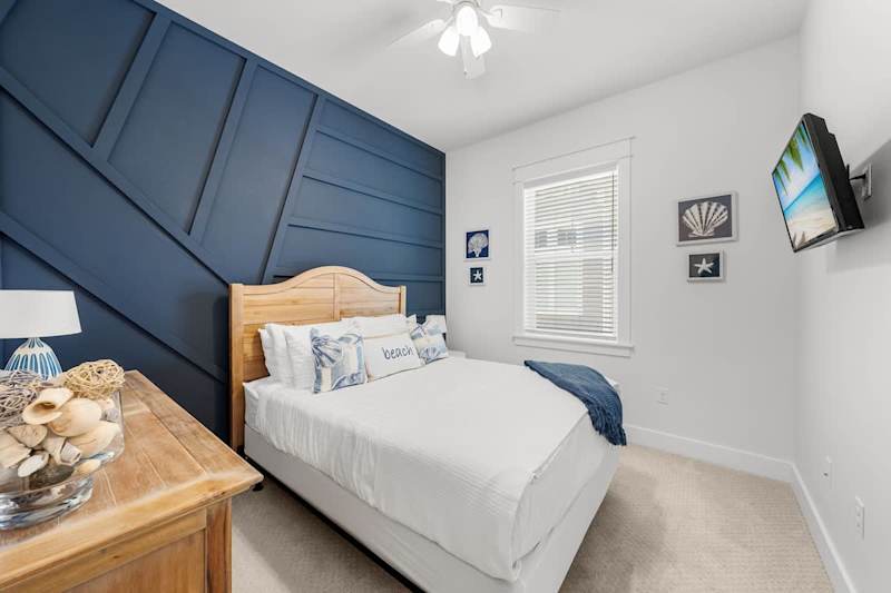 Bedroom #1 features a queen bed and smart tv.