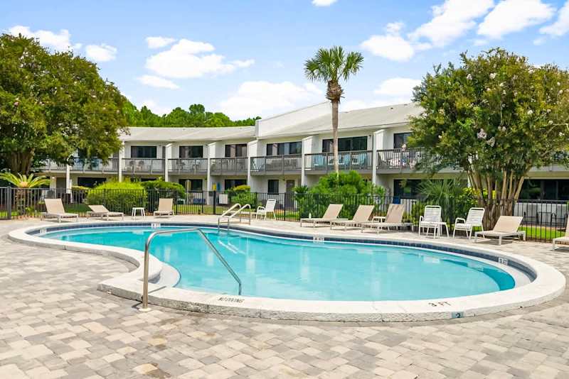 Community pool with lounge chairs.