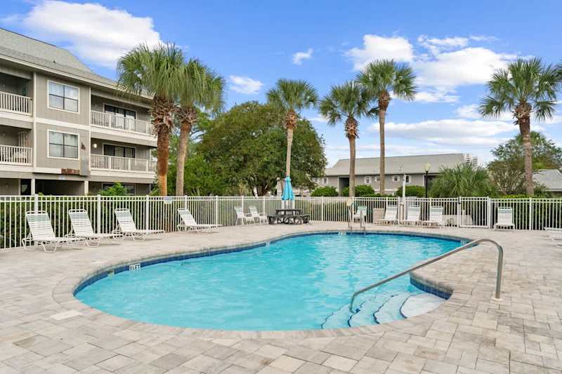 Community pool with lounge chairs.