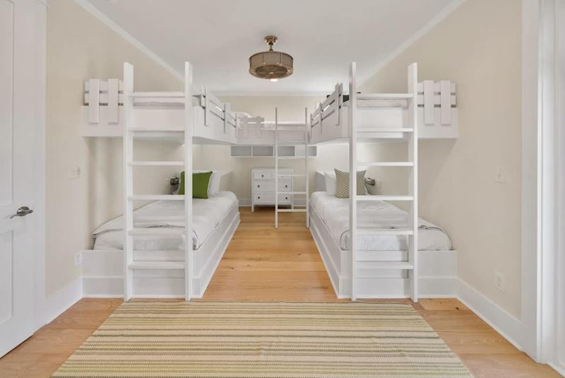 Bedroom #2 features (5) twin beds (built in bunks) with ensuite, smart tv, & access to covered balcony.