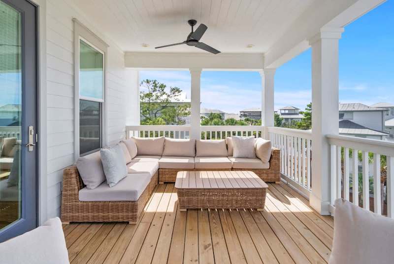 Third floor covered porch with seating.