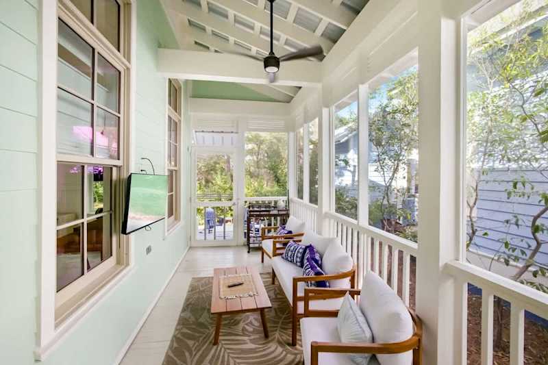 Private covered porch with seating & smart tv.