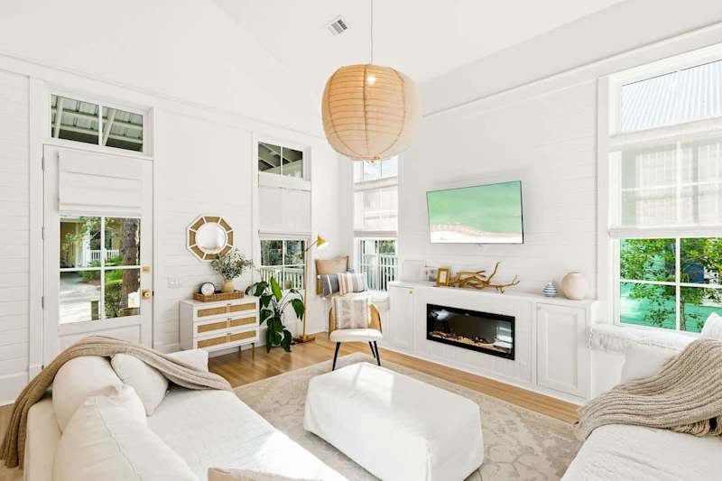 Living room features plenty of seating and a smart tv.