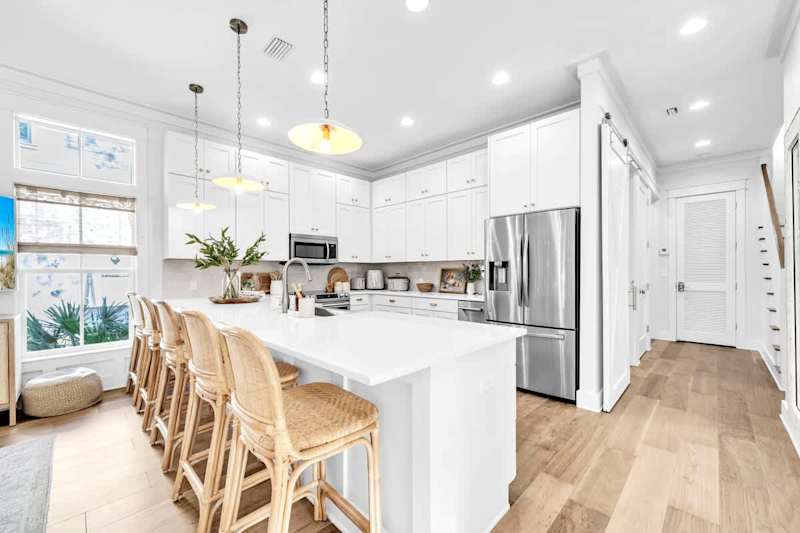 The fully equipped kitchen features island seating for four.