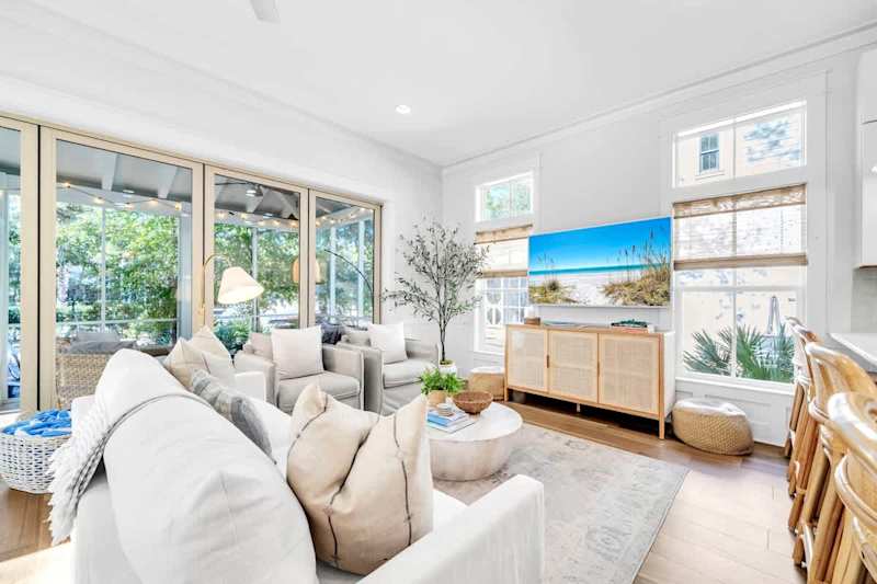 Living room features plenty of seating and a large smart TV for movie night streaming.