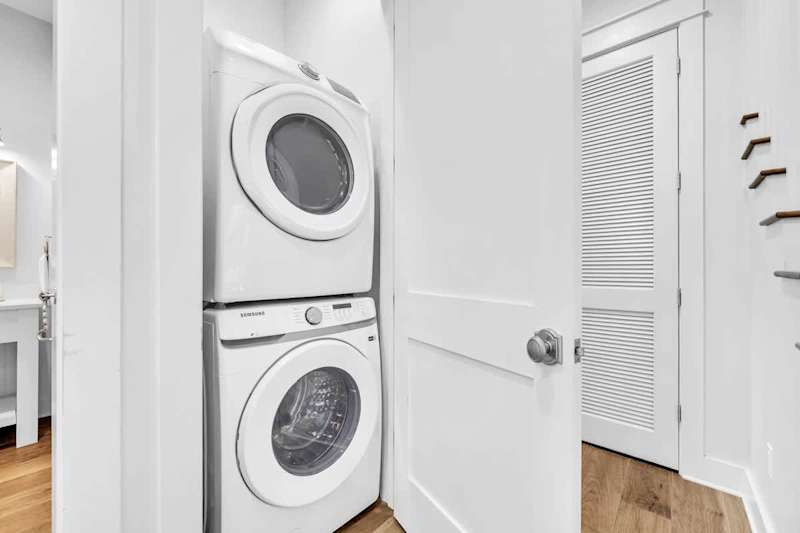 First floor laundry room features a full sized washer and dryer.
