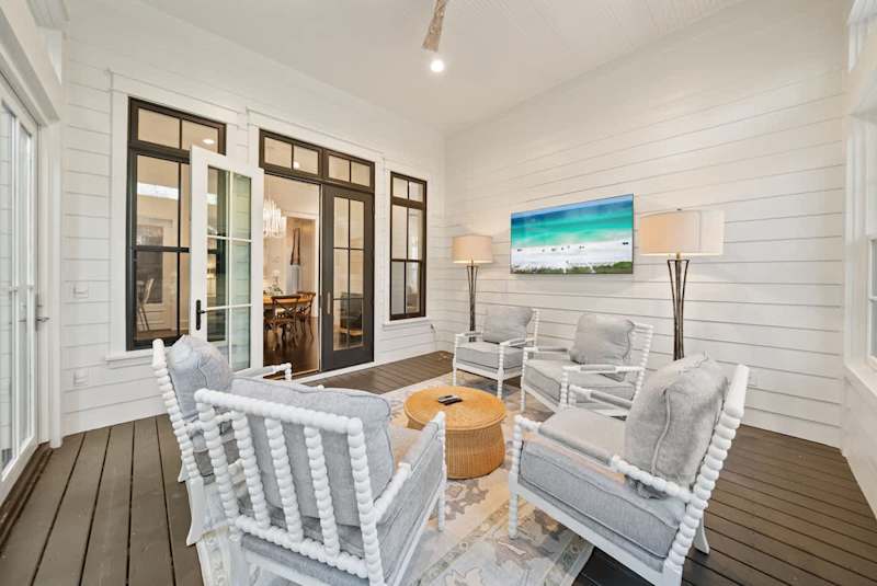 Den off the kitchen includes seating and a large screen smart tv.
