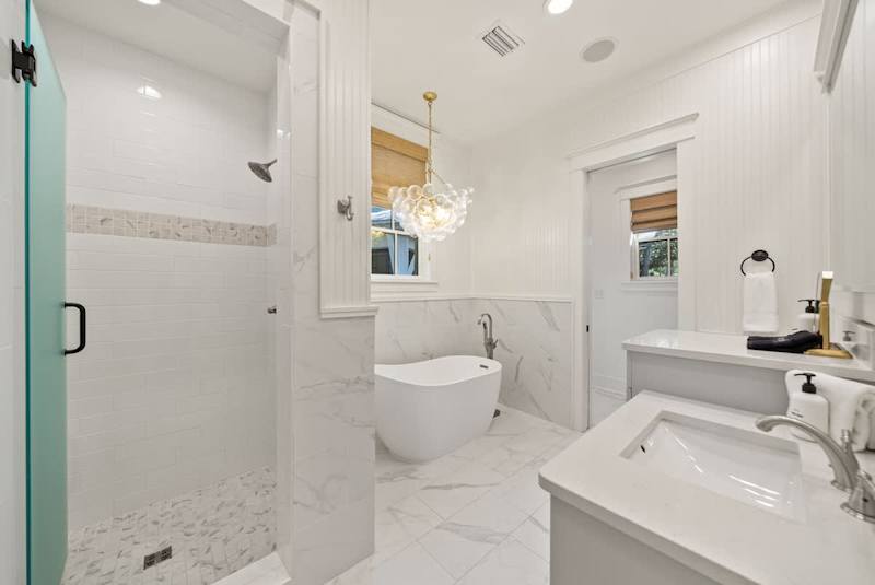 Ensuite features dual vanities, a walk-in shower and large soaking tub.