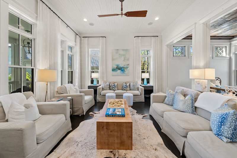 Living room features plenty of seating for all and a smart tv.
