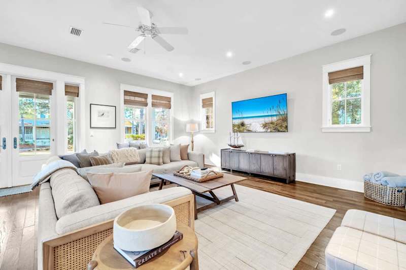 Living room includes plenty of seating and a smart tv for unwinding in the evenings.