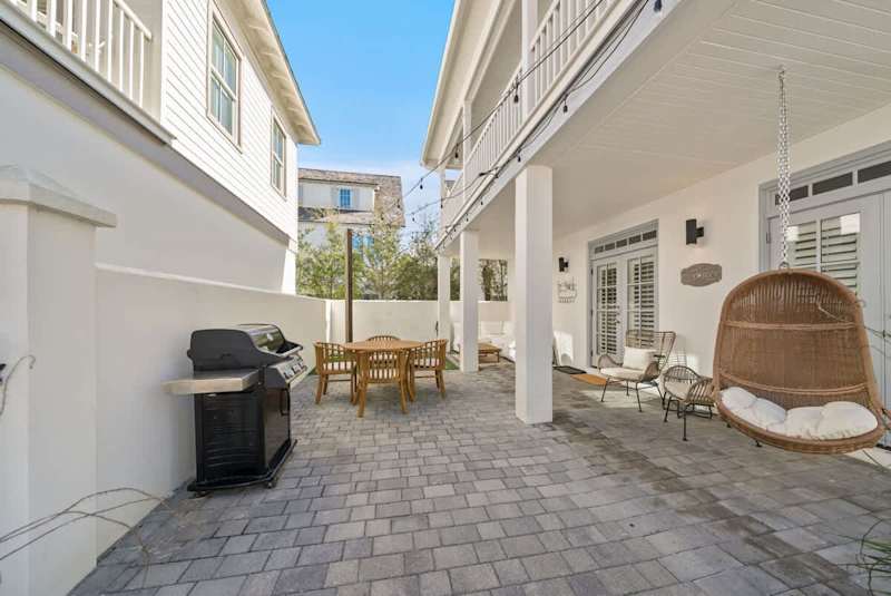 Terrace includes multiple seating options, outdoor dining area, putting green, and a gas grill.