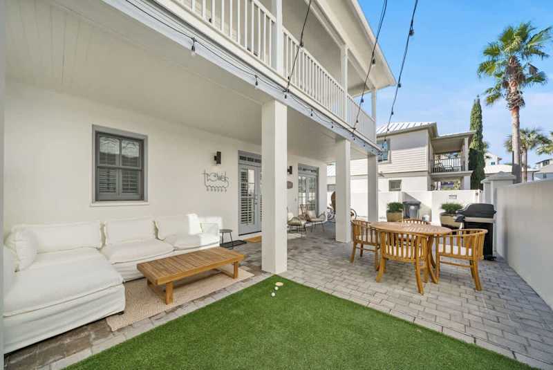 Terrace includes multiple seating options, outdoor dining area and a gas grill.