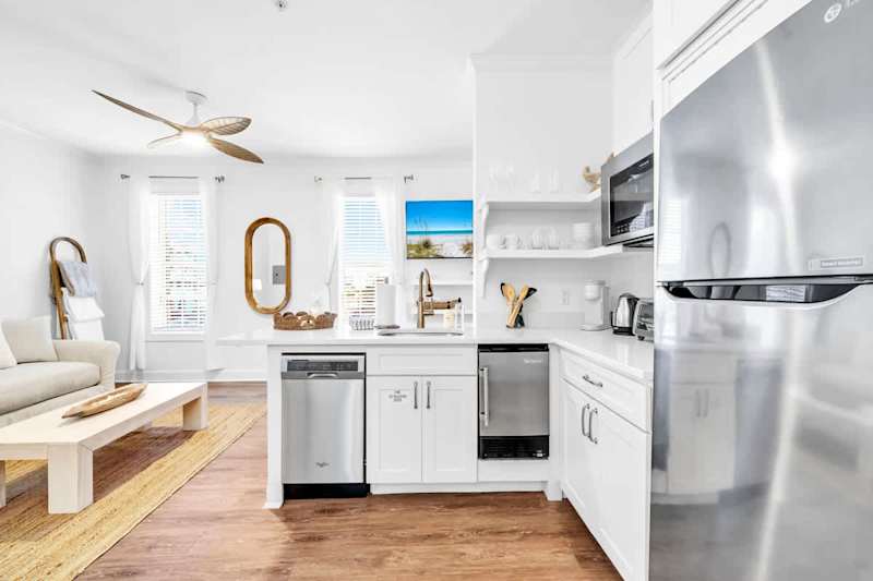 Kitchen in condo features a toaster over, microwave, dishwasher Keurig coffee maker, mini fridge/freezer, and dishes!