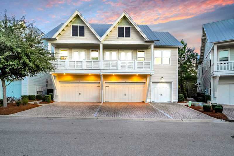 Home includes one driveway parking space in front of the right single garage door.