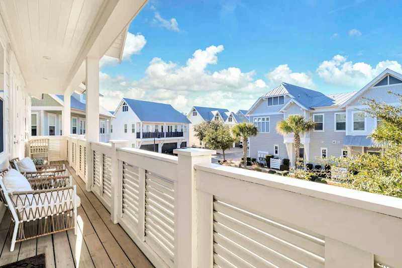 Expansive balcony with multiple seating options.