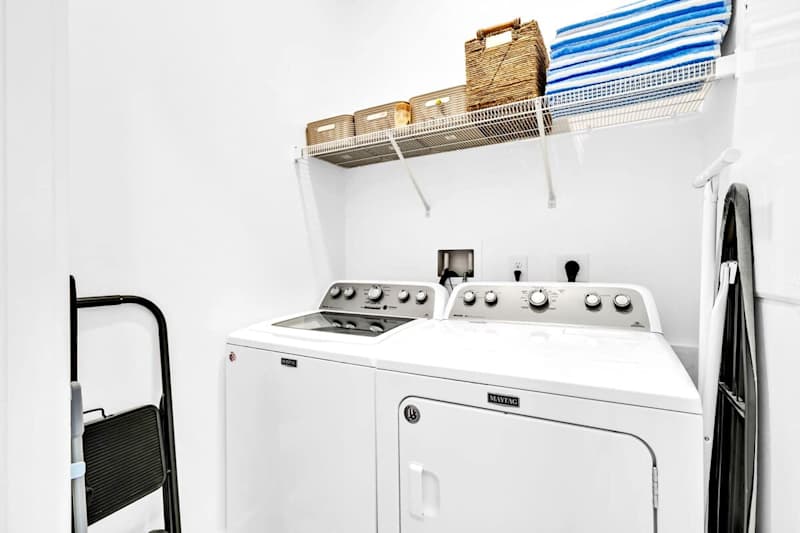 Laundry room features a full washer and dryer.