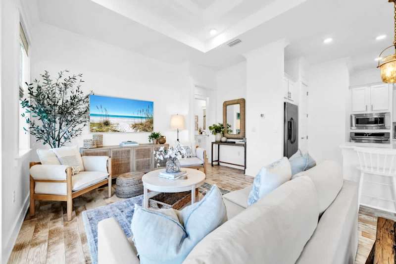 Living room features plenty of seating and a smart tv.