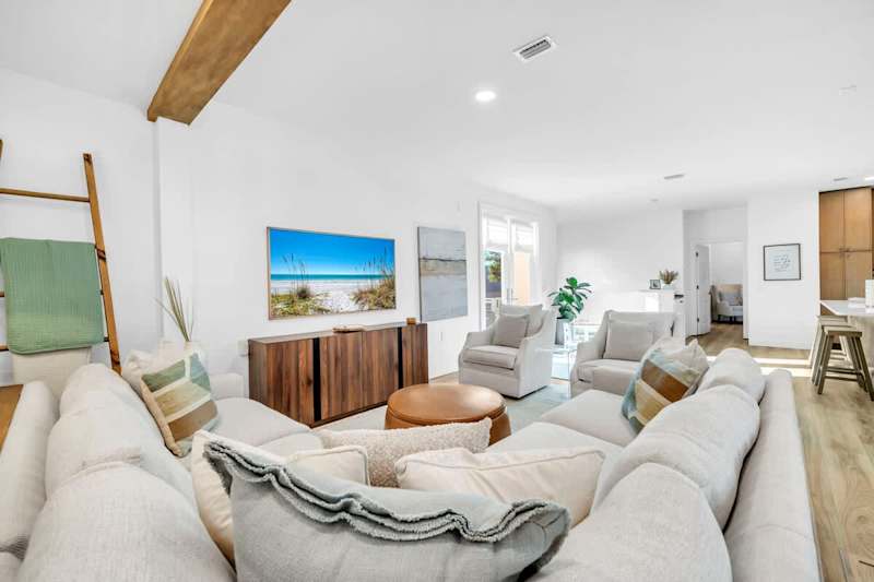 Living room features plenty of seating for all with the addition of a smart tv.