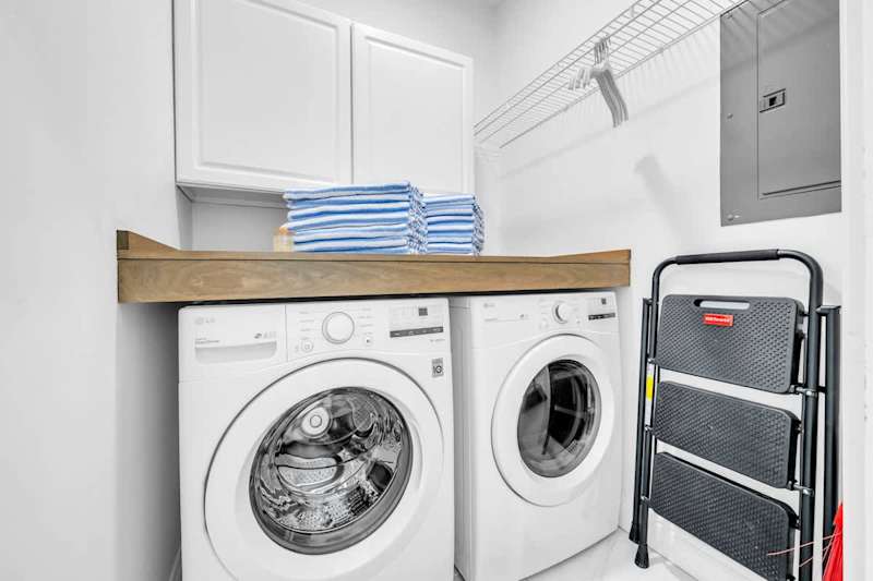 Laundry room on 1st floor features a full sized washer and dryer.