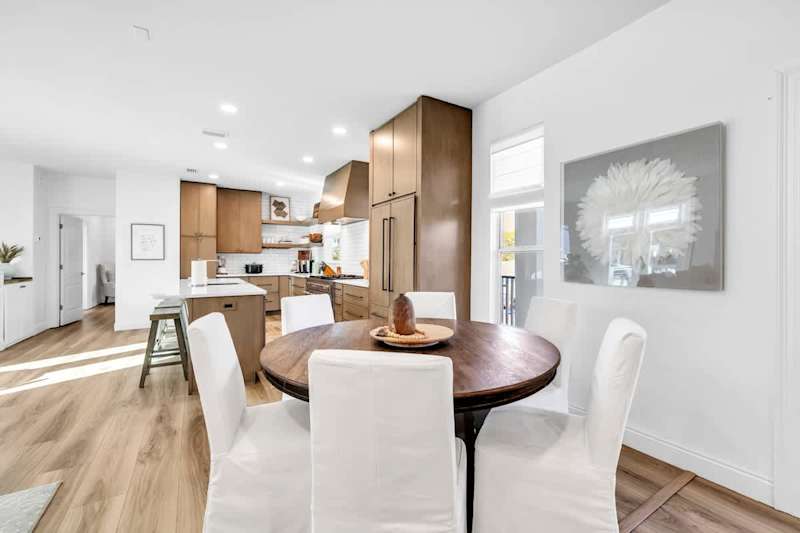 Dinging room table features seating for six with additional seating for four at the large kitchen island.