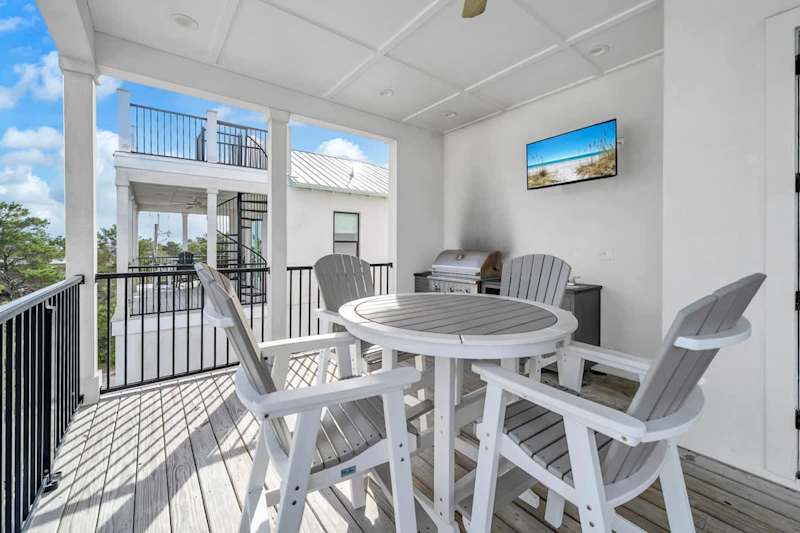 Third floor balcony retreat with seating and an outdoor grill!