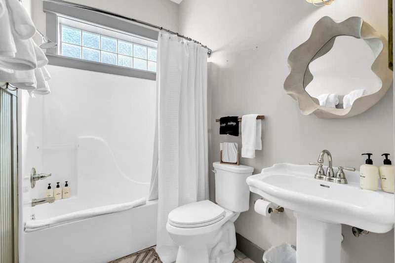 First floor hall bathroom featuring a shower/tub combo.