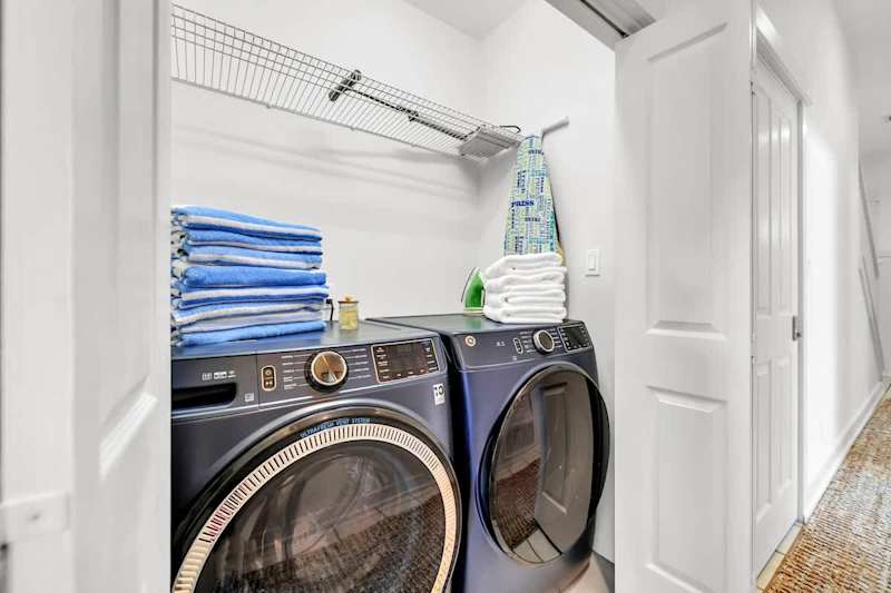 First floor laundry room features a full sized washer and dryer.