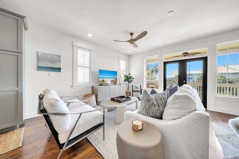 Living room features plenty of seating and a smart TV for movie night streaming.