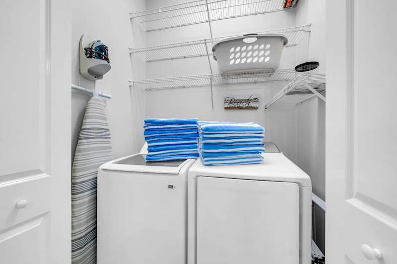 Laundry room features washer and dryer.