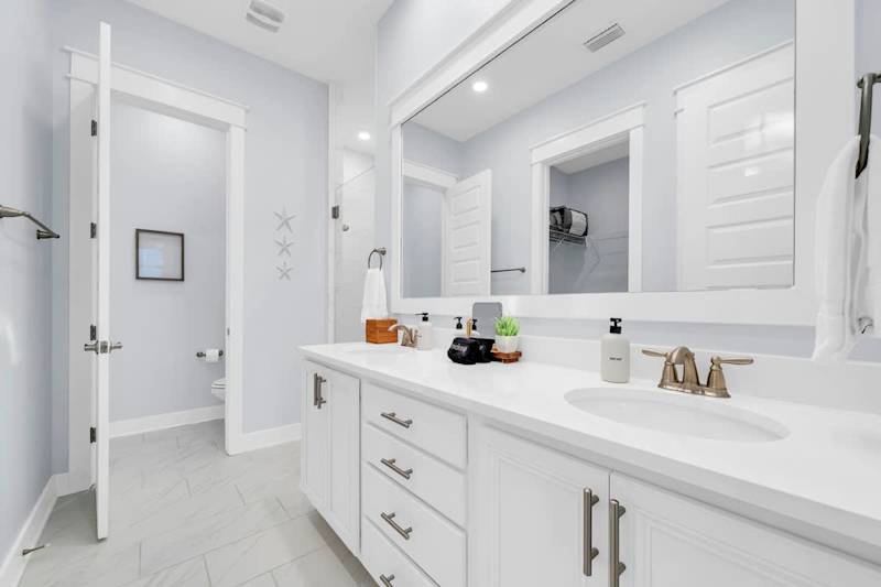 Primary bathroom comes equipped with dual vanities, walk-in closet, and walk-in shower.