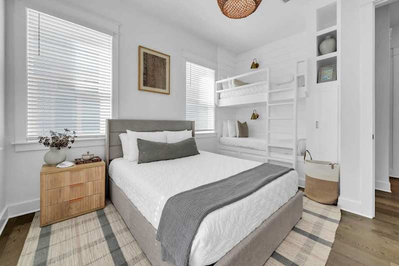 Queen with built in twin/twin bunk in guest bedroom, with smart tv, walk-in closet, and access to private porch.