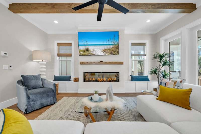 Living room features seating for all, smart tv, and fireplace